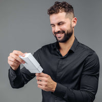Thumbnail for Man in black shirt joyfully unboxing Minimalist Photo Bracelet from Brother & Sisters.