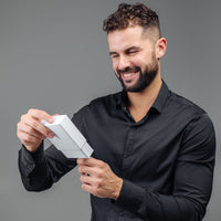 Thumbnail for Man smiling while opening a gift box containing the Minimalist Photo Bracelet by Brother & Sisters.