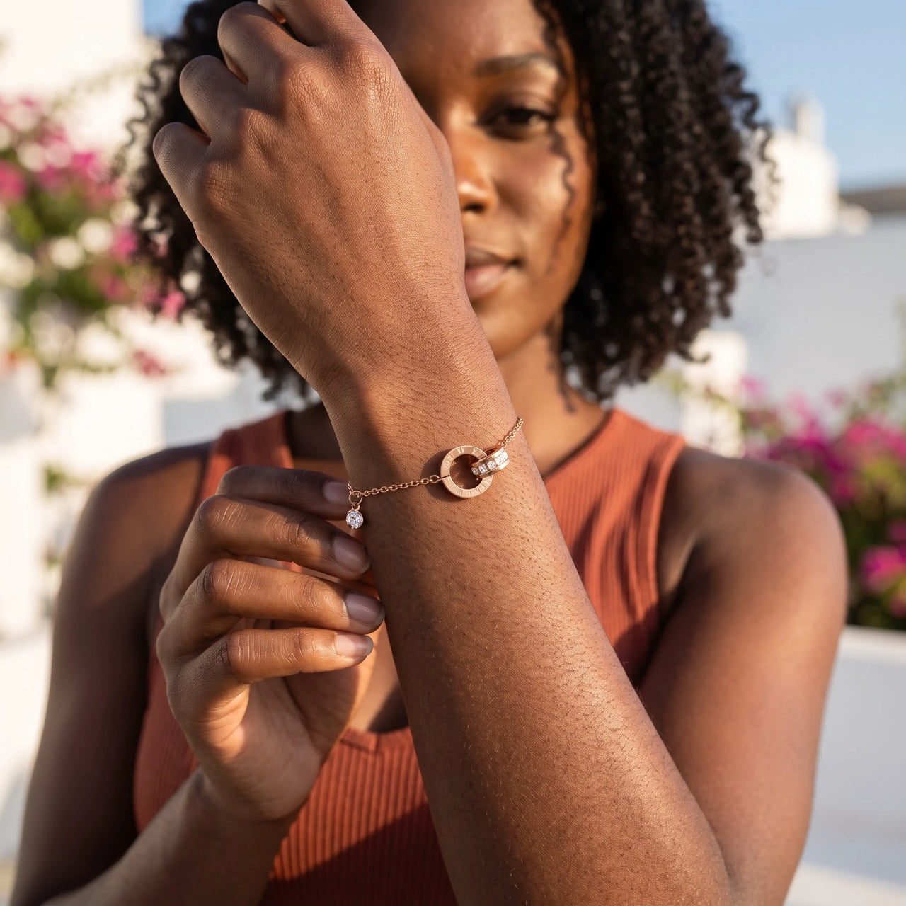Woman gently touching her rose gold bracelet | SKU: 25535338-rose-gold