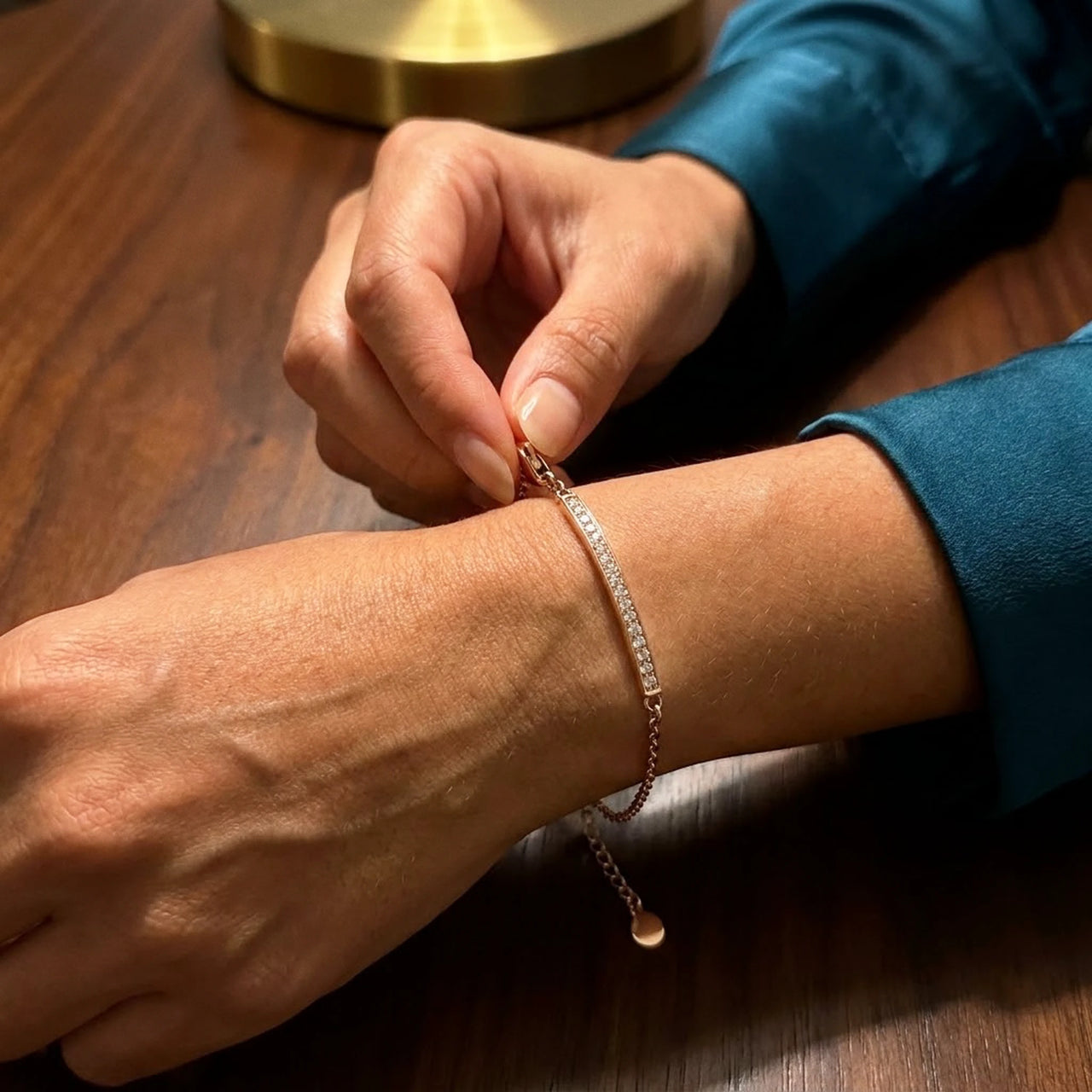 Adjusting the extension chain of the rose gold Crystal Bar Bracelet on the wrist