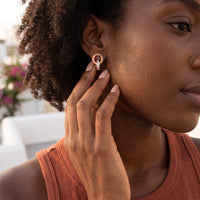 Thumbnail for Woman gently touching her rose gold huggie hoop earrings | SKU: 11137578-rose-gold