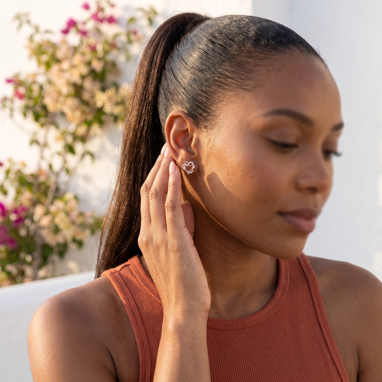 Woman gently touching her rose gold stud earrings | SKU: 419593-rose-gold