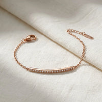 Thumbnail for Crystal Bar Bracelet in rose gold stainless steel, crystal-set bar, laid flat on linen