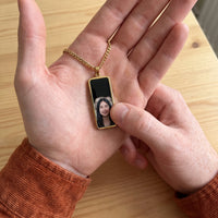 Thumbnail for Thumb warming the gold bar pendant: the hidden photo appears under the thumb while the rest stays black | SKU: TPH-BARN-GOLD