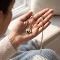 Thumbnail for The gold clover photo pendant with a grandmother's photo in an open palm, showing its real small size | SKU: TPH-CLVN-GOLD