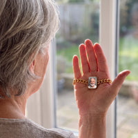 Thumbnail for Woman looking at her husband's photo in the gold cushion-cut photo bracelet resting in her palm | SKU: TPH-CUSB-GOLD