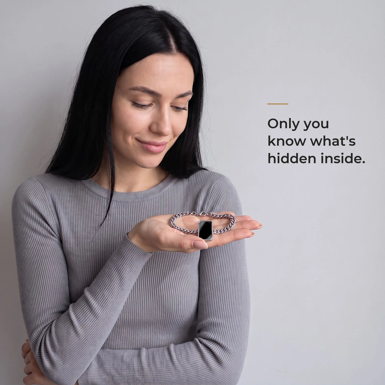 Woman holding the silver cushion-cut bracelet in her palm, its plaque plain black: only you know what's hidden inside | SKU: TPH-CUSB-SILVER