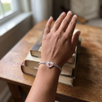 Thumbnail for The silver heart photo bracelet on her wrist, showing its real small size | SKU: TPH-HRTB-SILVER